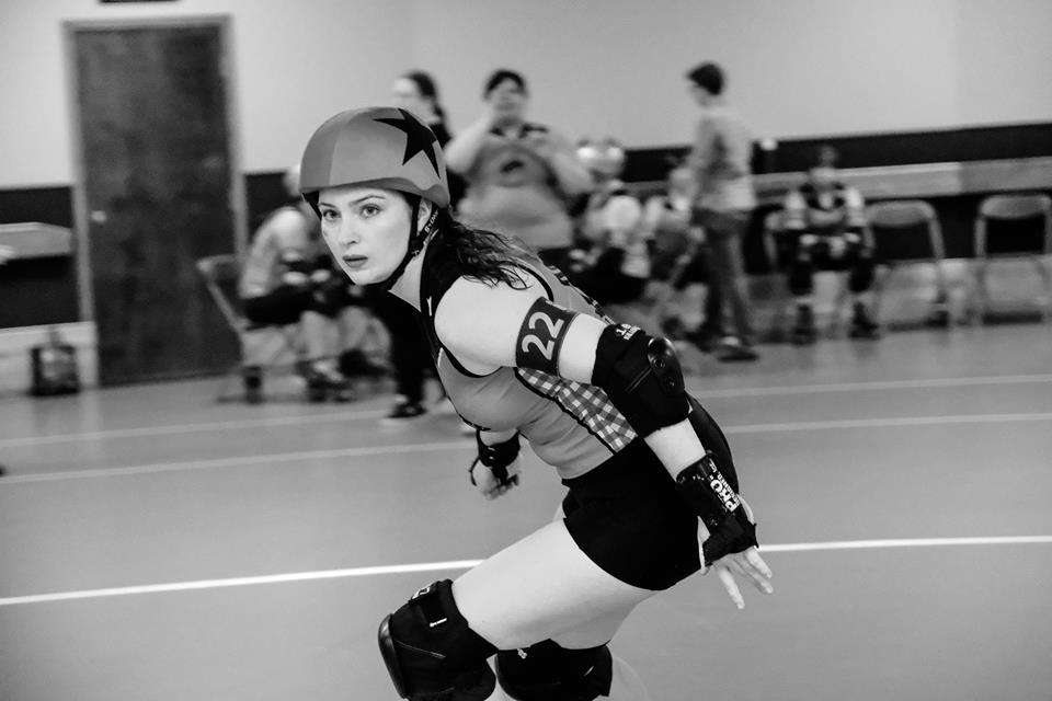 A roller derby jammer skated around the track. It's Hard Dash, who writes this blog