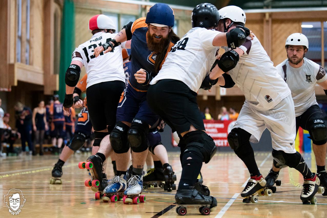 A jammer is breaking through a pack of roller derby skaters